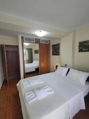 a bedroom with a large white bed with towels on it at Private pool & Panorama View on Athens center Hill in Athens