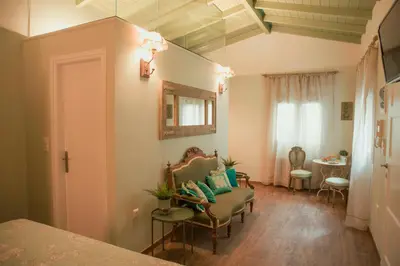 a room with a bed and a chair and a table at The Koukaki Residence in Athens