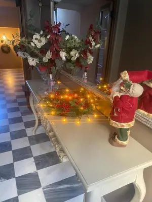 a table with christmas lights and vases with flowers at The Koukaki Residence in Athens