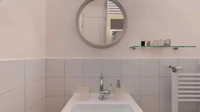 a white bathroom with a sink and a mirror at The Koukaki Residence in Athens