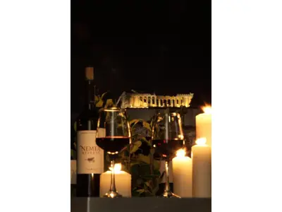a table with candles and wine glasses and lights at Athens View Loft - 01 in Athens