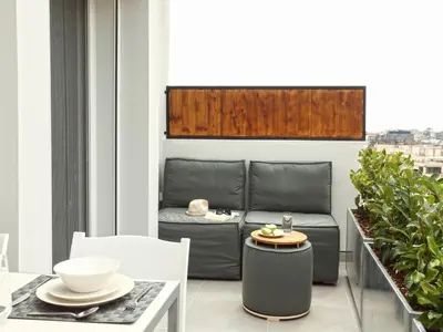 a balcony with a couch and a table and chairs at Athens View Loft - 01 in Athens
