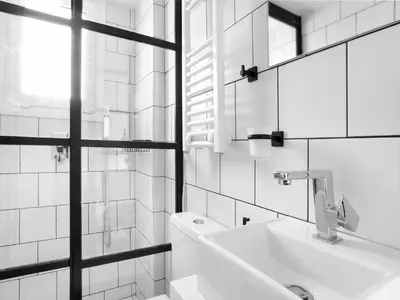 a white bathroom with a sink and a mirror at Athens View Loft - 01 in Athens