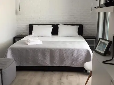 a bedroom with a bed with white sheets and white pillows at Athens View Loft - 01 in Athens