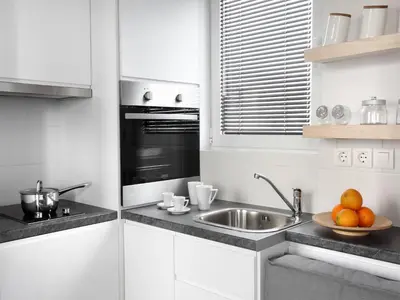 a white kitchen with a sink and a plate of fruit at Athens View Loft - 01 in Athens