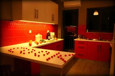 a kitchen with red walls and a counter with hearts on it at Acropolis View Dream in Athens