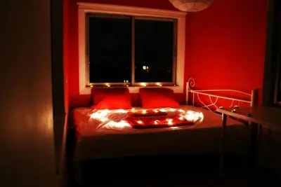a red room with a bed with red pillows and a window at Acropolis View Dream in Athens