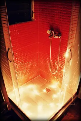 a bathroom with a shower with a red wall at Acropolis View Dream in Athens