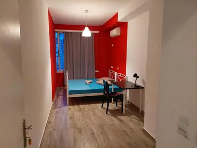 a bedroom with a bed and a desk and a table at Acropolis View Dream in Athens