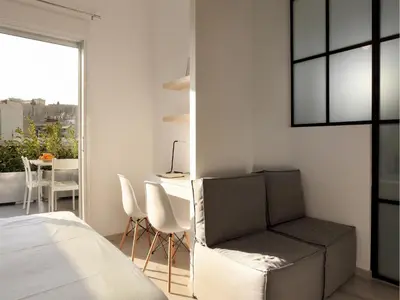a bedroom with a bed and a desk and a chair at Athens View Loft - 02 in Athens