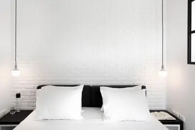a white bedroom with a bed with two white pillows at Athens View Loft - 03 in Athens
