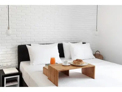 a white bed with a wooden coffee table on it at Athens View Loft - 04 in Athens