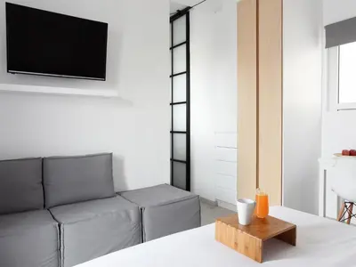 a living room with a couch and a tv at Athens View Loft - 04 in Athens