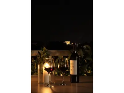 two wine glasses and a bottle of wine on a table at Athens View Loft - 04 in Athens