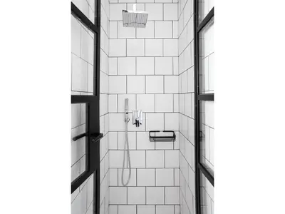 a bathroom with a shower with white tiles at Athens View Loft - 04 in Athens