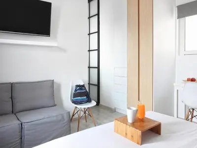 a living room with a couch and a chair at Athens View Loft - 04 in Athens