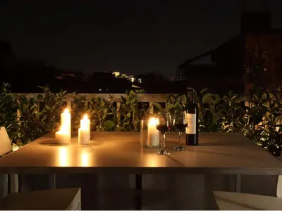 a table with candles and wine glasses and wine bottles at Athens View Loft - 04 in Athens