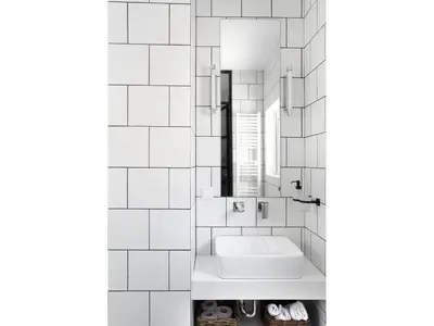 a white bathroom with a sink and a mirror at Athens View Loft - 04 in Athens