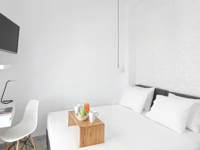 a white bedroom with a bed with a wooden tray on it at Athens View Loft - 05 in Athens