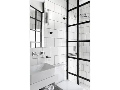 a black and white bathroom with a sink and a mirror at Athens View Loft - 05 in Athens