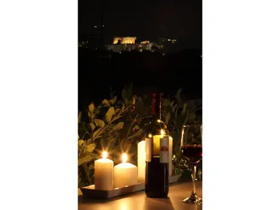 a table with candles and a bottle of wine at Athens View Loft - 05 in Athens