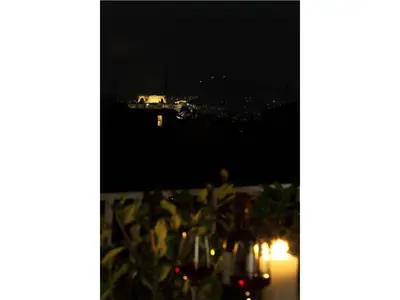 a table with a view of the city at night at Athens View Loft - 06 in Athens