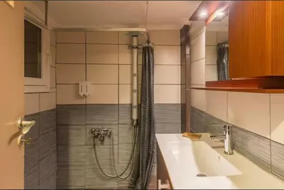 a bathroom with a shower and a sink at Holodek Apartments Ground & SemiBasement in Athens