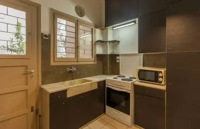 a kitchen with a sink and a stove at Holodek Apartments Ground & SemiBasement in Athens