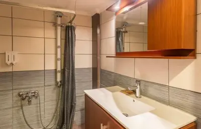 a bathroom with a sink and a shower at Holodek Apartments Ground & SemiBasement in Athens