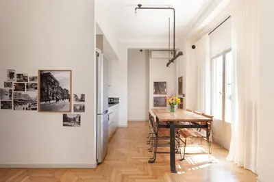 a kitchen and dining room with a table and a window at Hidesign Athens Luxury Apartments in Kolonaki in Athens