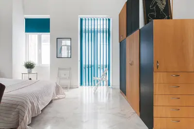 a bedroom with a large dresser and a bed at Concierge Downtown in Athens