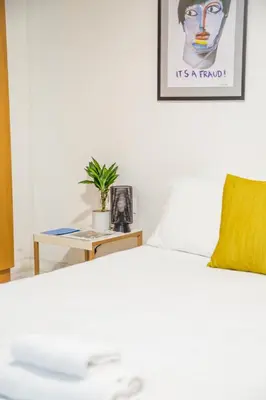 a bedroom with a bed and a picture on the wall at Concierge Downtown in Athens