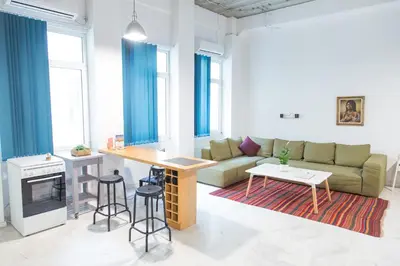 a living room with a couch and a table at Concierge Downtown in Athens