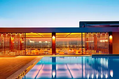 a house with a pool and a view of the city at Zeus Wyndham Grand Athens in Athens