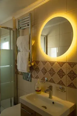 a bathroom with a sink and a mirror at Studio Acropolis in Athens