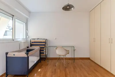 a room with a bed and a chair in it at Elvita Spata Luxurious Villa in Spáta