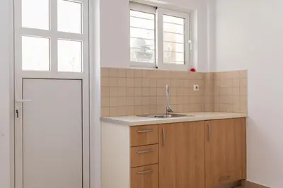 a kitchen with a sink and a window at Elvita Spata Luxurious Villa in Spáta