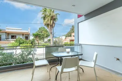 a balcony with a table and chairs and a view at Elvita Spata Luxurious Villa in Spáta
