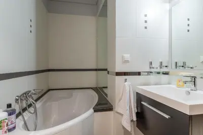 a white bathroom with a tub and a sink at Elvita Spata Luxurious Villa in Spáta