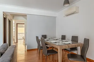 a dining room with a table and chairs and a couch at Elvita Spata Luxurious Villa in Spáta