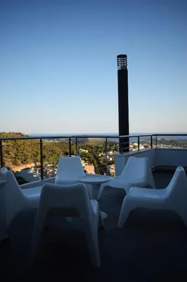 a group of chairs and a table on a balcony at Panorama Penthouse & Studios in Athens
