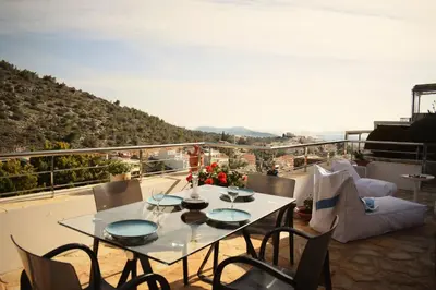 a table and chairs on a balcony with a view at Panorama Penthouse & Studios in Athens