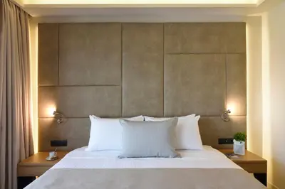 a bedroom with a large bed with white pillows at Athens Avenue Hotel in Athens