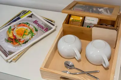 a wooden box with two spoons and a box of food at Dema Luxury Suites - Perikleous E1 in Athens