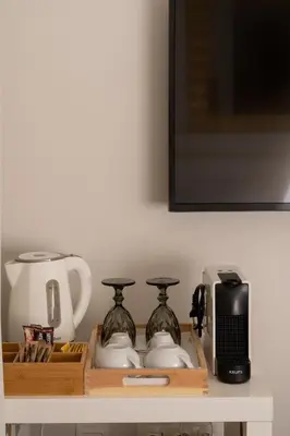 a shelf with two vases and a toaster and a microwave at Dema Luxury Suites - Perikleous E1 in Athens