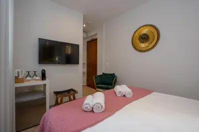 a bedroom with a bed with two towels on it at Dema Luxury Suites - Perikleous E1 in Athens