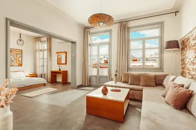 a living room with a couch and a bed at Suitas in Athens