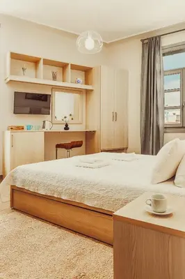 a bedroom with a large bed and a table at Suitas in Athens