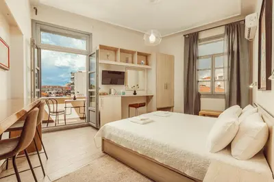 a hotel room with a bed and a large window at Suitas in Athens