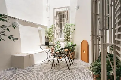 a balcony with a table and chairs and plants at 1930's Athenian House by YHA in Athens